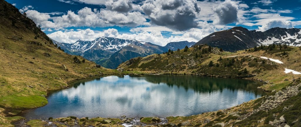 Wide panoramic vista over Tristaina lake in Pyrenees,Andorra