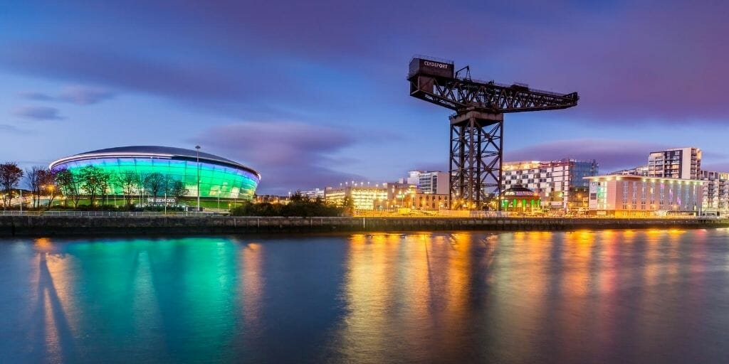Finnieston Crane in Glasgow during sunset with lights reflecting in the Clyde river