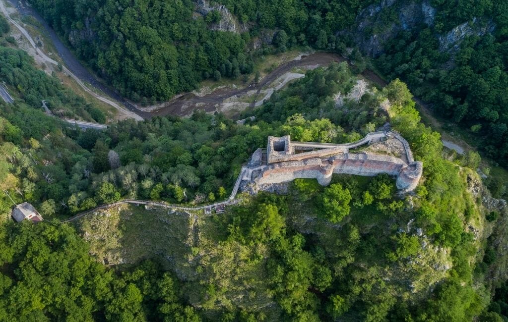 Aerial view of Poenari Castle Dracula Romania on a wooded hill in Romania