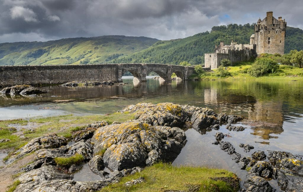 Eilean Donan Castle with water and arched bridge Scotland in 7 Days