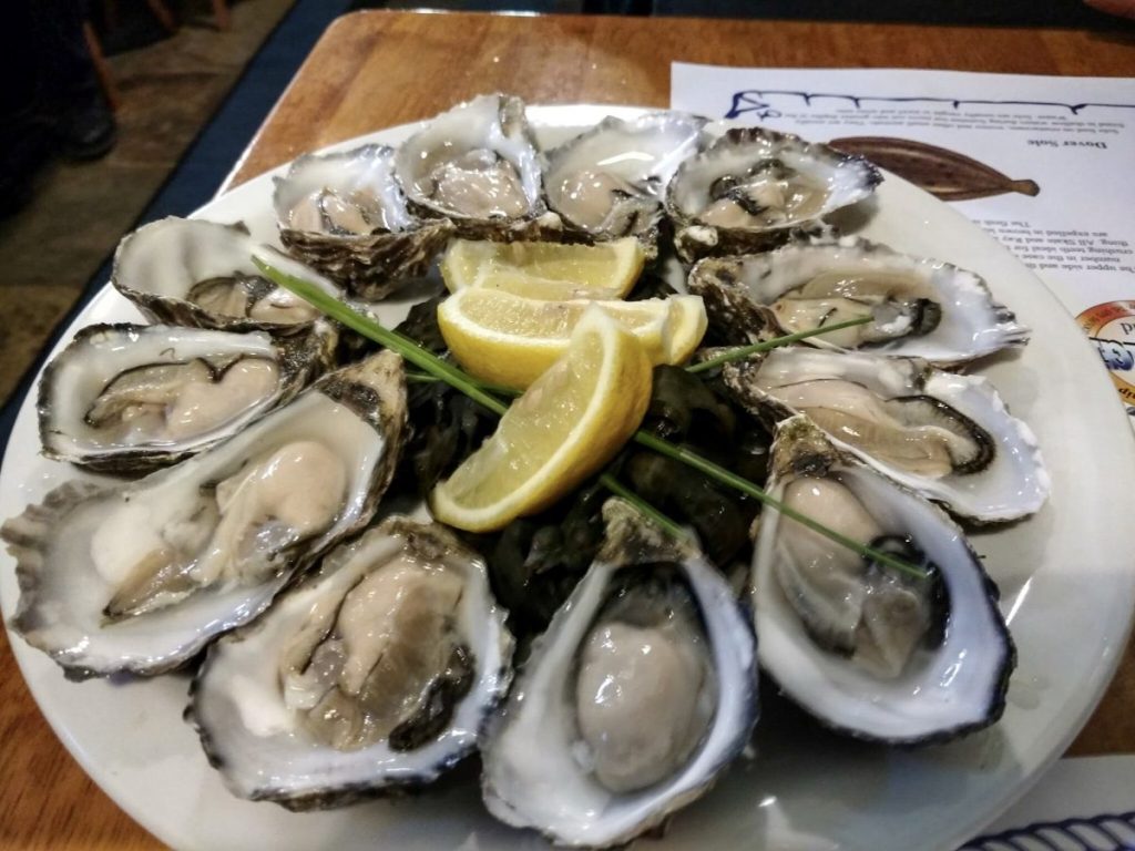 large platter with raw oysers and lemon in Galway Ireland