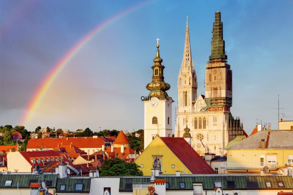 Zagreb Cathedral spires with rainbow in the sky