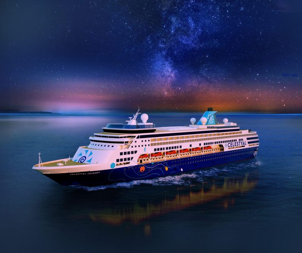 aerial shot of celestyal journey cruise ship under a star-y night sky