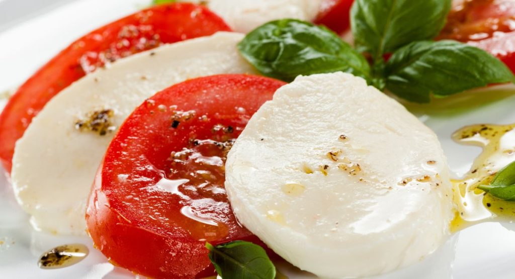 Closeup of a Caprese Salad with tomatos, mozarella, and basil