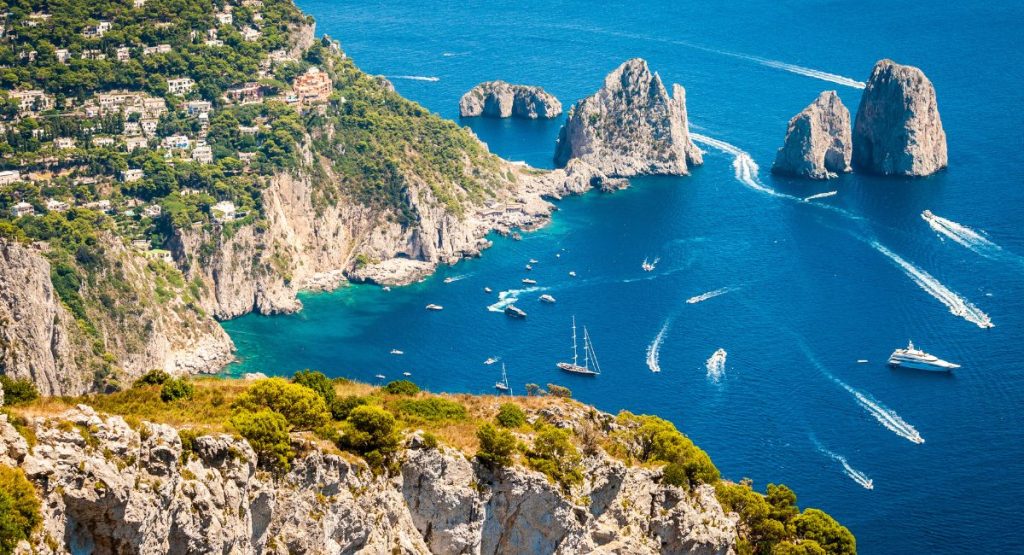 View from the hillside overlooking the boats in the water below in Capri Italy