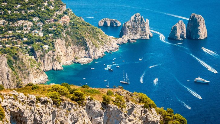 View from the hillside overlooking the boats in the water below in Capri Italy